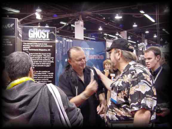 Blii gives a CD to Dick Dale, the father of surf guitar, at NAMM 2003
